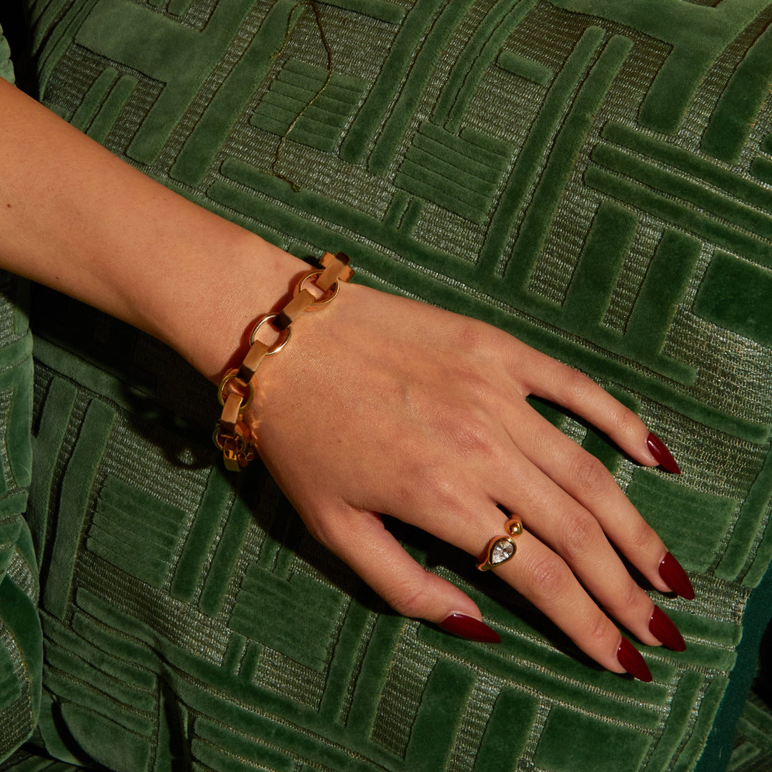 Hand with a ring on a green textured surface